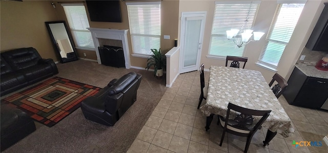 1910 Deerfield Way, Harker Heights, TX 76548 - living room featuring light tile patterned flooring, a fireplace, baseboards, a chandelier, and light carpet