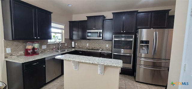 1910 Deerfield Way, Harker Heights, TX 76548 - kitchen with appliances with stainless steel finishes, a sink, light tile patterned floors, and light stone countertops