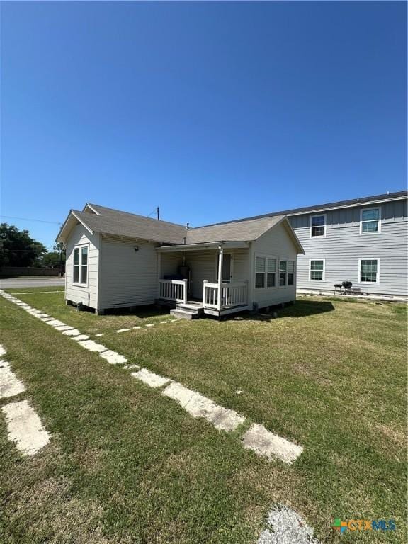 back of house with a lawn