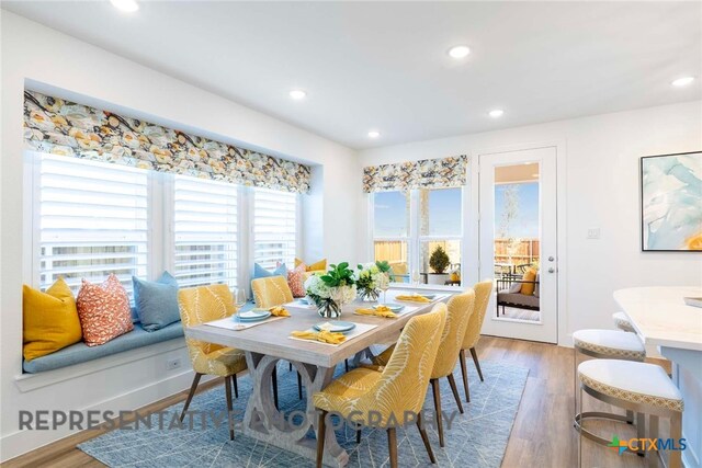 dining space with recessed lighting and wood finished floors