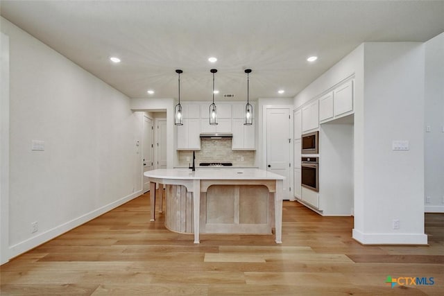 1826 Nettletree Rd, New Braunfels, TX 78132 - kitchen with appliances with stainless steel finishes, white cabinets, tasteful backsplash, recessed lighting, and light countertops