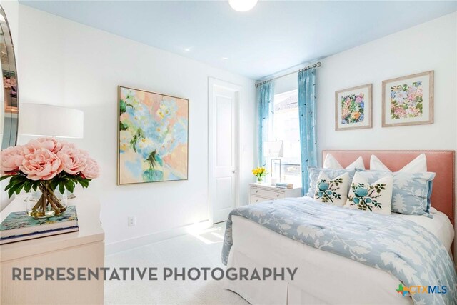 carpeted bedroom with baseboards