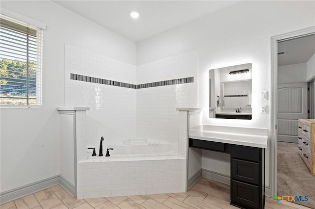 bathroom featuring tile patterned floors, plus walk in shower, and vanity