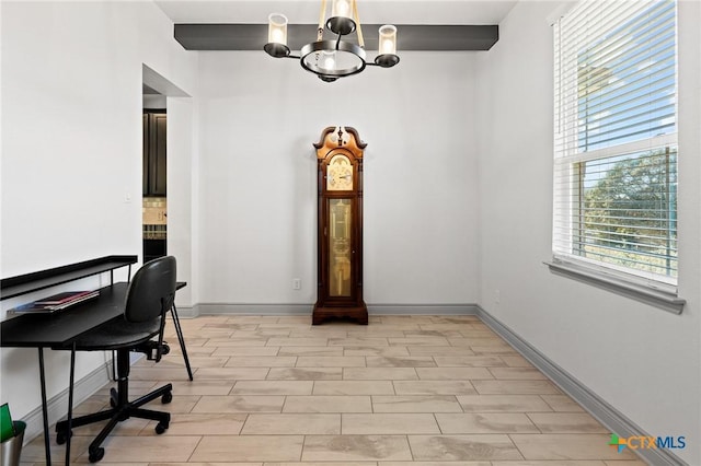 home office featuring a healthy amount of sunlight and a notable chandelier