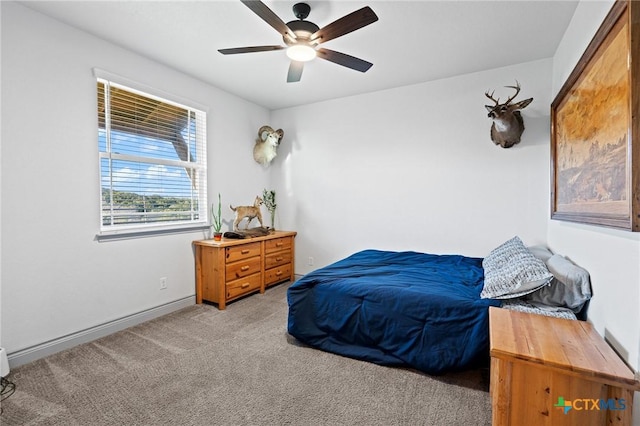 bedroom with ceiling fan and light carpet