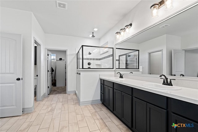 bathroom featuring vanity and a shower with shower door