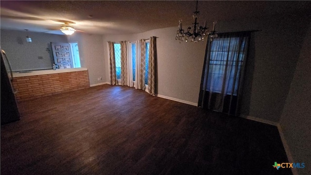 4002 El Capitan Dr, Temple, TX 76502 - unfurnished dining area with dark wood-type flooring, baseboards, a chandelier, and a ceiling fan