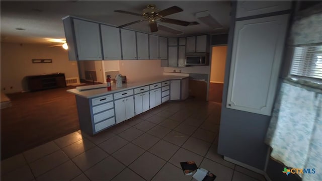 4002 El Capitan Dr, Temple, TX 76502 - kitchen with stainless steel microwave, a ceiling fan, tile patterned floors, and white cabinets