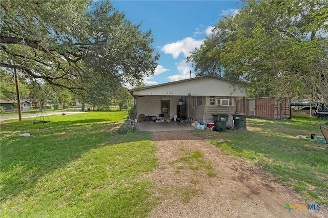 401 Walnut St, Hallettsville, TX 77964 - rear view of property featuring a lawn and dirt driveway