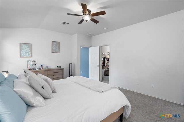 bedroom with vaulted ceiling, ceiling fan, a spacious closet, carpet floors, and a closet