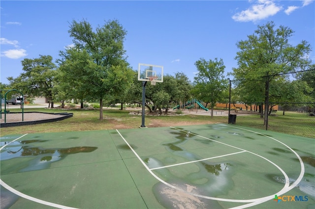 view of sport court featuring a playground