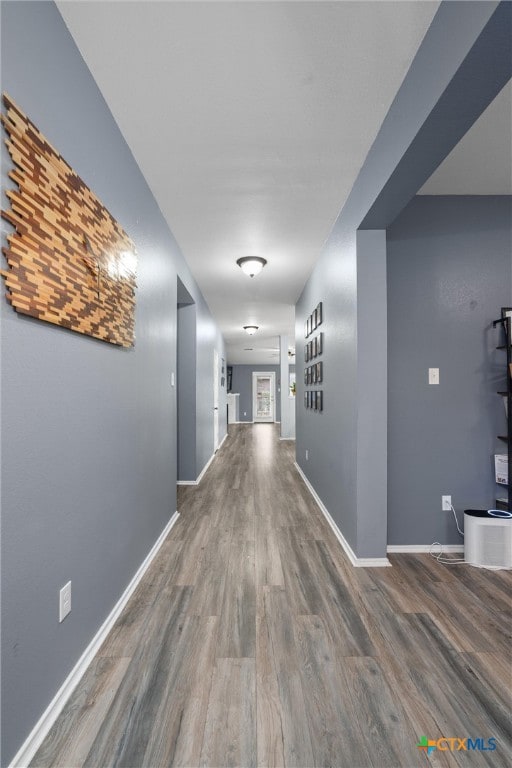 hallway with hardwood / wood-style flooring