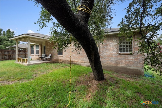 back of house with a patio area and a yard