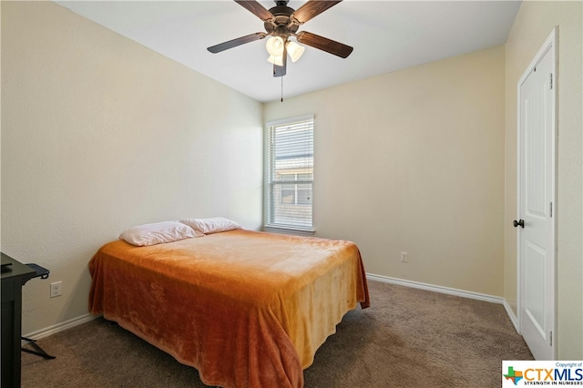 bedroom featuring ceiling fan and dark colored carpet