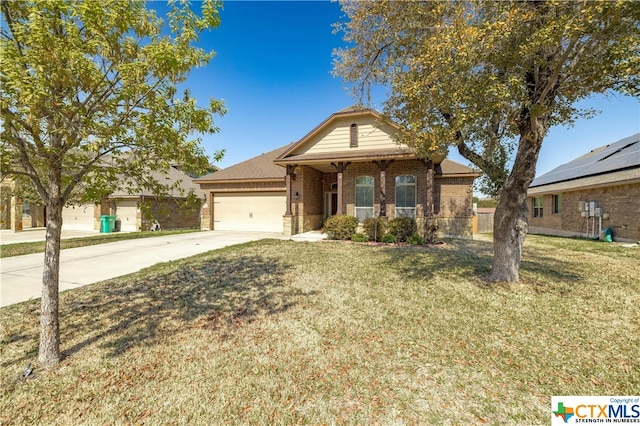 view of front of home with a front yard and a garage