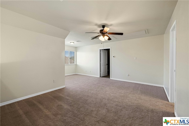 carpeted spare room featuring ceiling fan