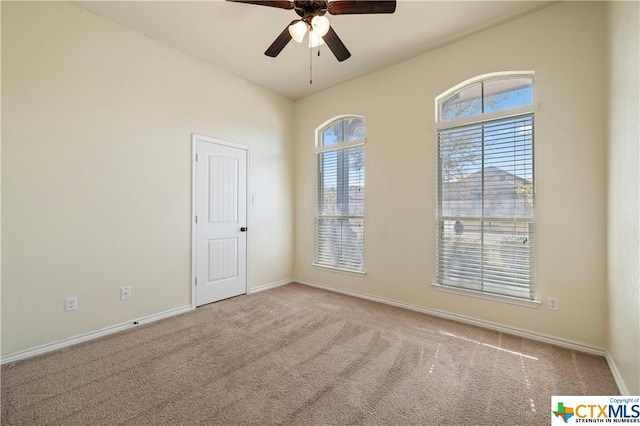 carpeted empty room with ceiling fan