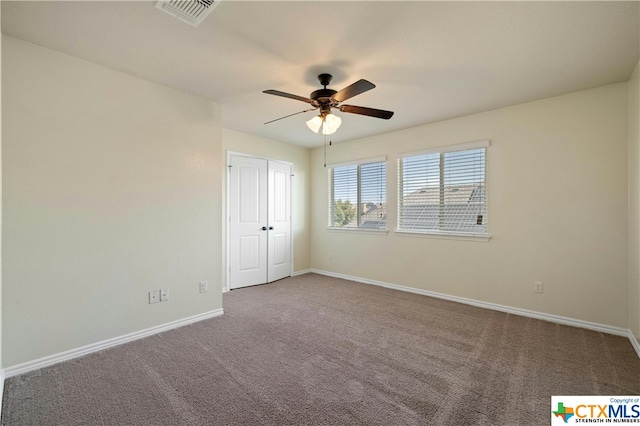 spare room with carpet and ceiling fan