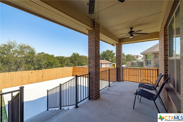 view of patio featuring a balcony and ceiling fan