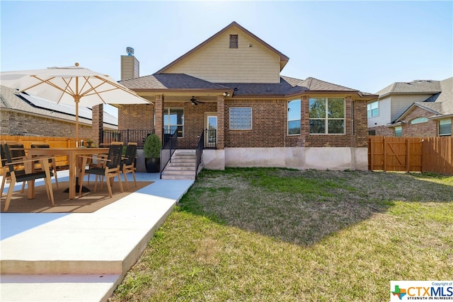 rear view of property with a patio, a lawn, and ceiling fan