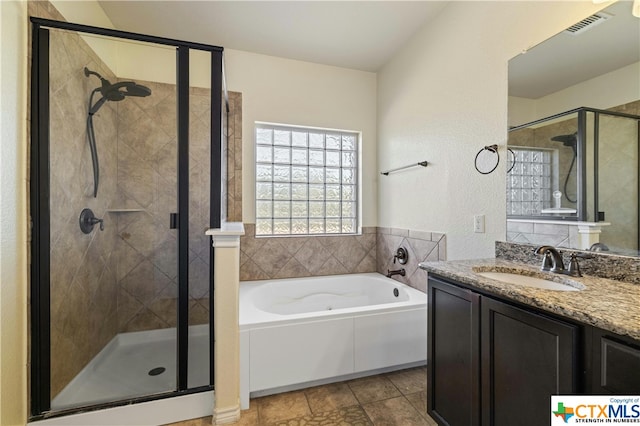 bathroom featuring shower with separate bathtub and vanity