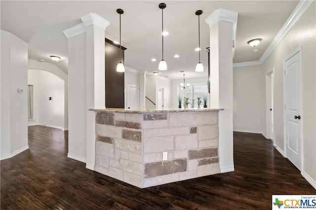 kitchen featuring dark hardwood / wood-style flooring, pendant lighting, kitchen peninsula, and light stone countertops