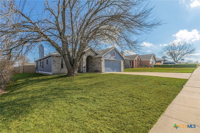 view of front of property featuring a garage and a front yard