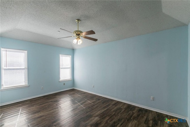 spare room with dark wood-type flooring, a textured ceiling, and ceiling fan