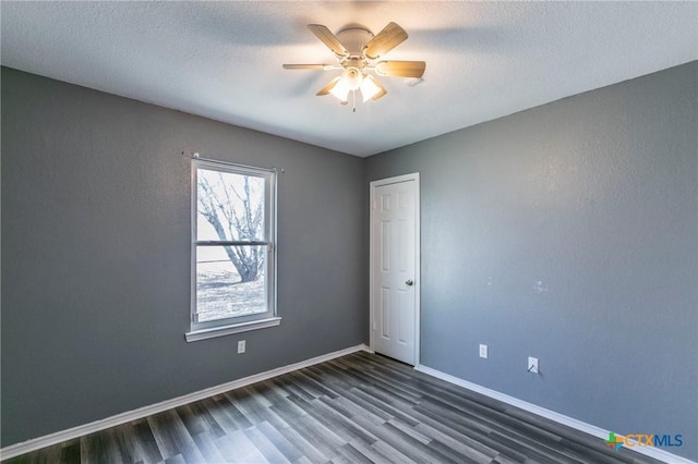 unfurnished room with dark hardwood / wood-style flooring, a textured ceiling, and ceiling fan