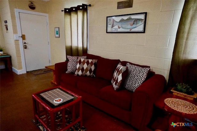 living area featuring concrete block wall