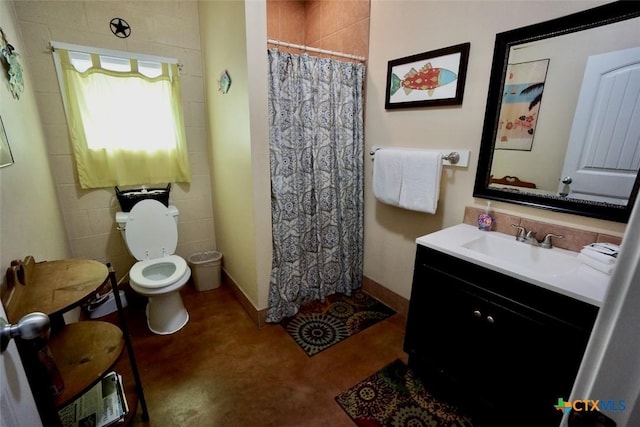 bathroom featuring toilet, vanity, and a shower with curtain