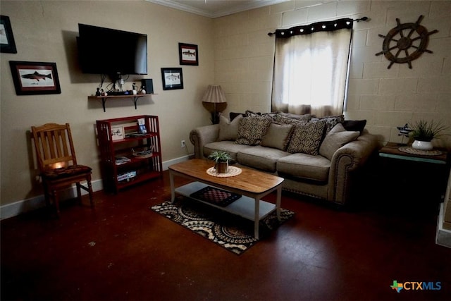 living room featuring wood finished floors, baseboards, and ornamental molding