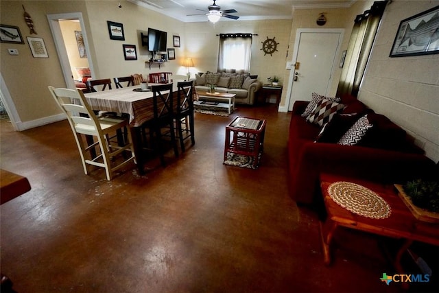 living room featuring ornamental molding, baseboards, concrete floors, and ceiling fan