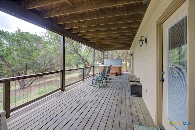 deck featuring a hot tub