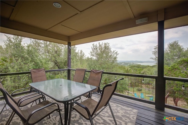wooden terrace with outdoor dining space