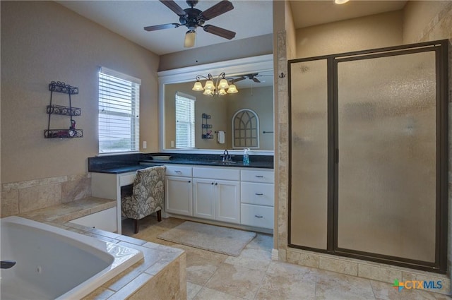 full bathroom featuring a whirlpool tub, a shower stall, ceiling fan with notable chandelier, and vanity