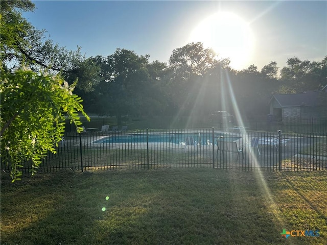 view of pool with fence, a fenced in pool, and a yard
