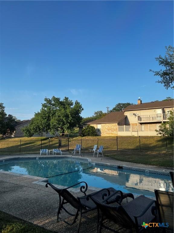 view of swimming pool with a fenced in pool, a patio, and fence