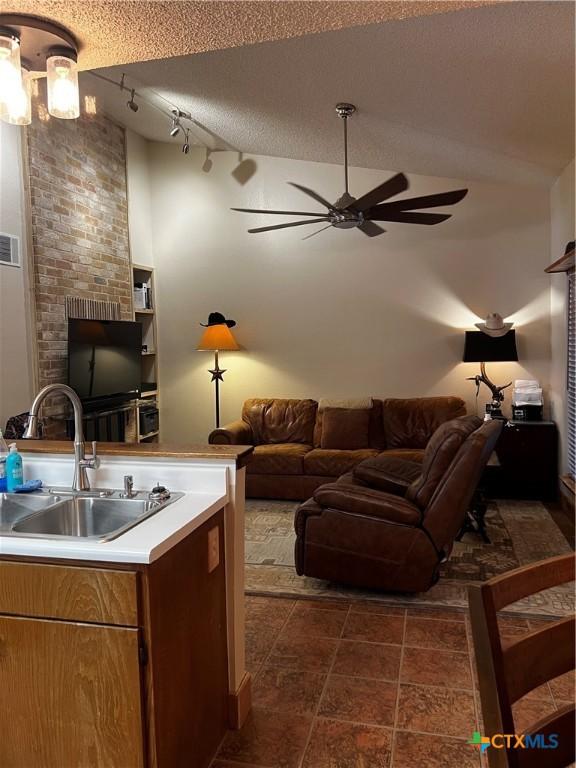 living room with visible vents and ceiling fan