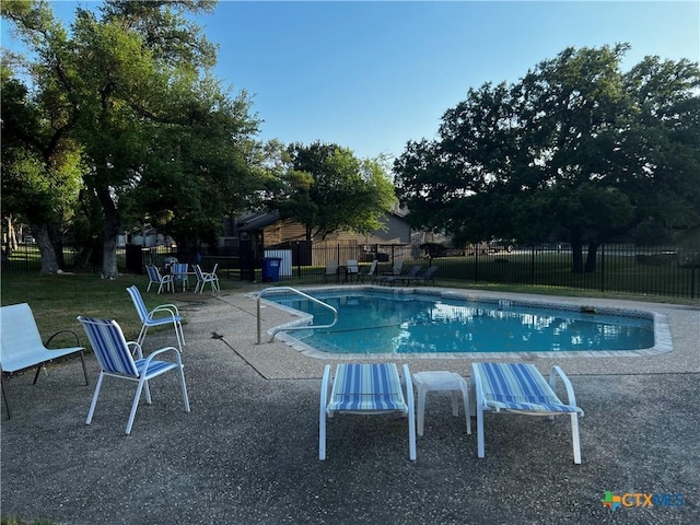 view of pool with a fenced in pool, a patio, and fence