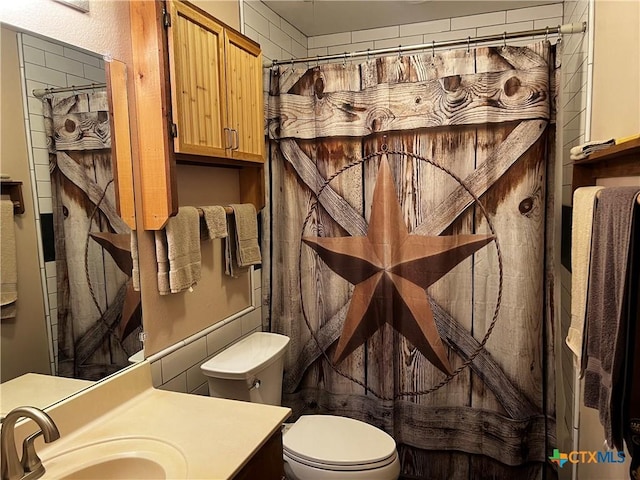 bathroom featuring toilet and vanity