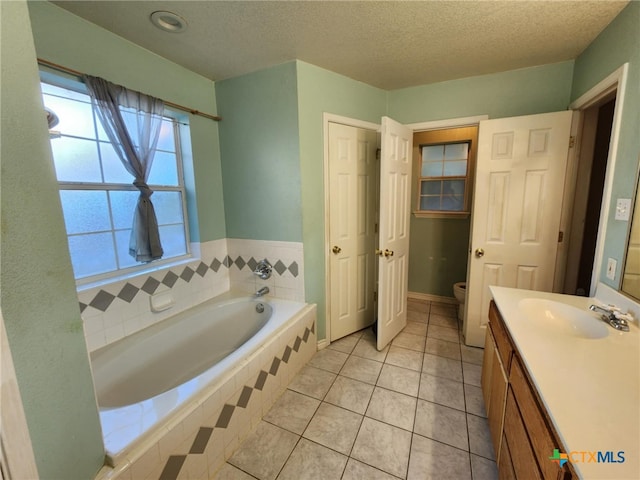 2006 Indian Camp Trl, Copperas Cove, TX 76522 - bathroom featuring a bath, vanity, tile patterned flooring, and a textured ceiling