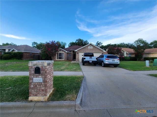 2006 Indian Camp Trl, Copperas Cove, TX 76522 - ranch-style house featuring a front lawn, concrete driveway, an attached garage, and brick siding