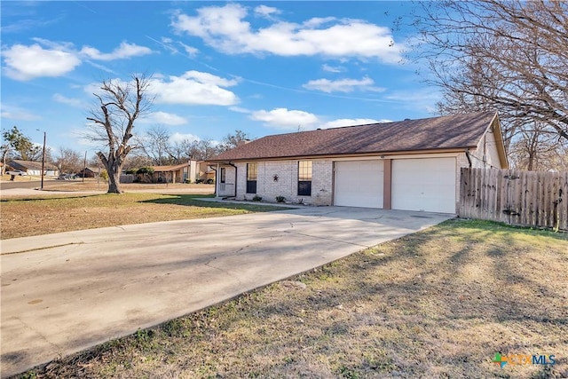 single story home featuring a garage and a front lawn