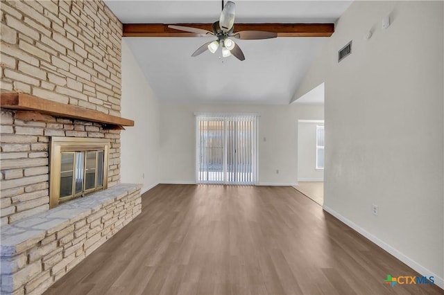 unfurnished living room featuring a brick fireplace, wood-type flooring, and lofted ceiling with beams