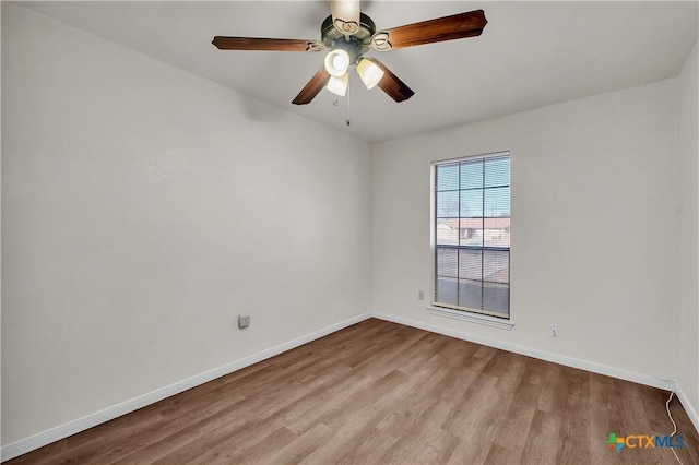 spare room featuring light wood-type flooring and ceiling fan