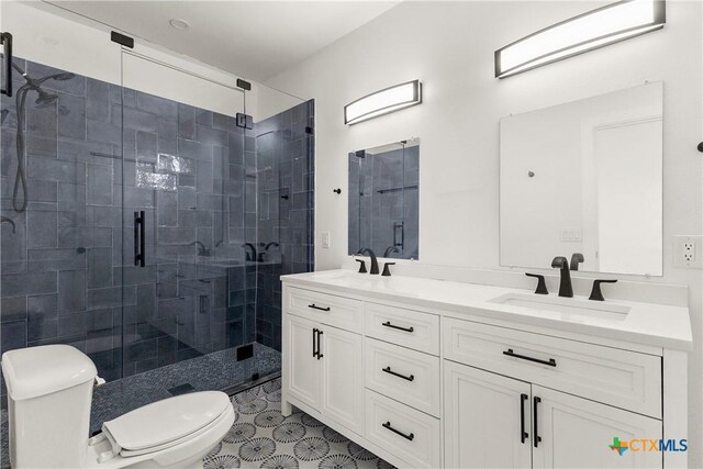 324 Idaho St, San Antonio, TX 78203 - full bathroom with toilet, a shower stall, and double vanity
