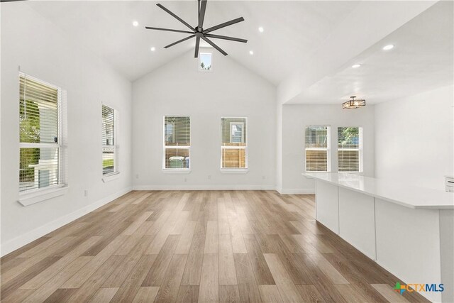 324 Idaho St, San Antonio, TX 78203 - unfurnished living room featuring ceiling fan, light wood-style flooring, recessed lighting, baseboards, and high vaulted ceiling