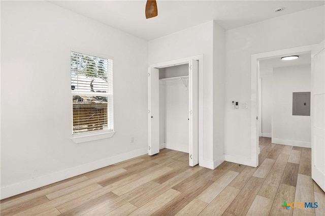 324 Idaho St, San Antonio, TX 78203 - unfurnished bedroom featuring light wood-style flooring, electric panel, baseboards, and a closet