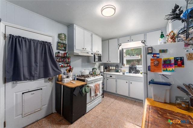 1802 Vine St, Georgetown, TX 78626 - kitchen with white appliances, under cabinet range hood, white cabinetry, and light countertops